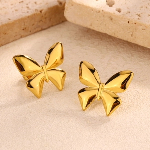 Macro detail of gold-plated butterfly earrings with a polished finish and 3D wing texture