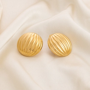 Detailed view of gold plated stainless steel stud earrings with vertical striped texture