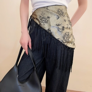 Detail of vintage gold silk waist belt with black rose floral print and long tassels