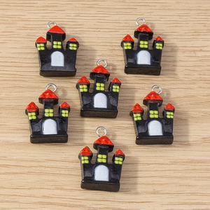 Detailed view of DIY Halloween castle pendants with bright colors on wooden background