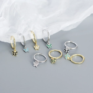 Detail of s925 silver butterfly earrings with colorful zircon drops in gold and silver