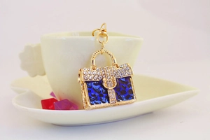 Macro shot of gold handbag keychain with blue leopard print and sparkling rhinestones