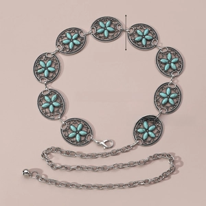 Detailed close-up of Bohemian turquoise waist chain with silver oval floral metal links