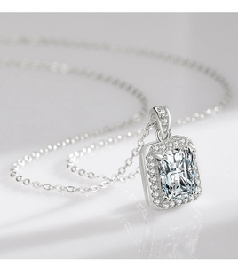 Macro detail of 925 sterling silver necklace with emerald cut zircon and pavé setting