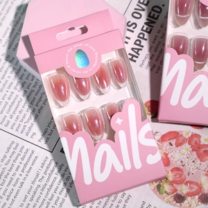 Pink gradient almond press-on nails set with aurora shimmer in elegant packaging