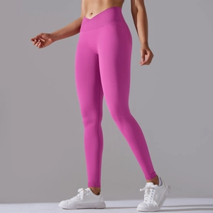 Detail view of seamless yoga leggings in rose pink featuring a V-shaped crossover waistband