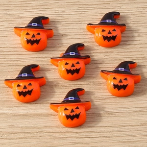 Set of six resin pumpkin charms with black wizard hats on a light wood background