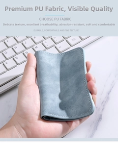 Close-up of slim blue PU leather card holder with premium matte texture and fine stitching