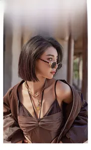 Detail of retro oval leopard print sunglasses with stylish gold layered chain necklace