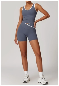 Detail of high-waist yoga shorts with cross V-waist design and white contrast piping