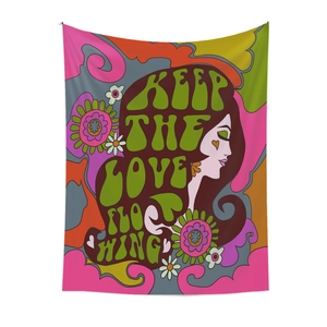 Detail of retro colorful tapestry with Keep the Love Flowing text for wall decor