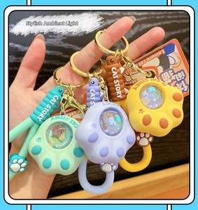 Miniature cat paw sunset lamp keychains in mint green, purple and yellow colors