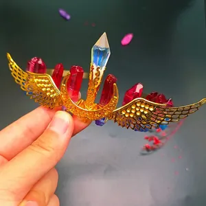 Handmade gold wing and moon bridal headband featuring vibrant red raw crystal points