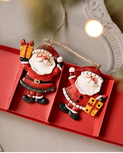 Detail of handcrafted Santa resin ornaments with gifts and rustic twine hangers