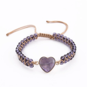 Detail showing handcrafted purple heart stone bead and woven cord of the heart bracelet