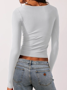 Rear view of a white long-sleeve crop top showing fit and square collar design