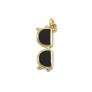 Macro shot of gold-plated sunglasses pendant with black enamel fill for jewelry making