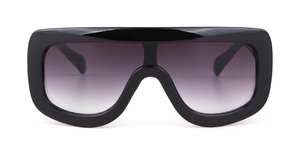 Detail view of oversized pilot sunglasses with black glossy frame and grey gradient lens
