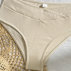 Close-up of beige ribbed high-waisted bikini bottoms with stylish V-cut waist detail