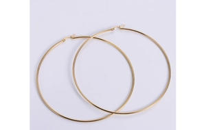 Detailed view of polished gold hoop earrings with secure classic snap closure