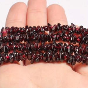Macro detail of deep red garnet chips beads for DIY jewelry making and necklaces