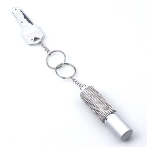 Detailed view of a silver keychain with sparkling rhinestones and a cylindrical container
