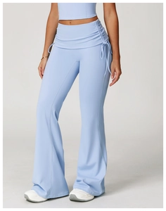 Detail of high waisted yoga flare pants in light blue featuring side drawstring ruching