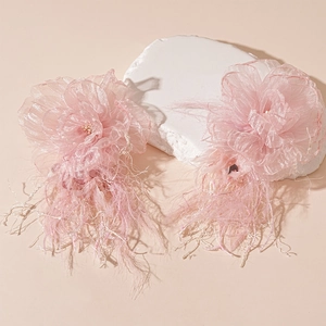 Detail of pink lace flower earrings with soft feather tassels and silver needles