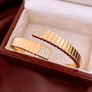 Macro detail of gold plated square bangle with pavé crystals in vintage jewelry box