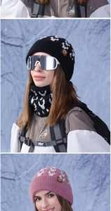 Detail of winter knitted hat and neck warmer set with faux leather logo and jacquard pattern