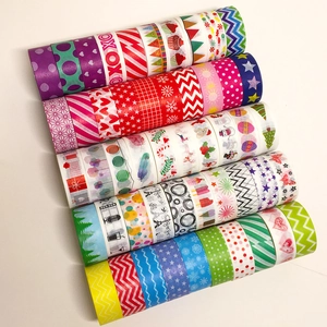 Macro view of colorful Washi tapes with geometric patterns and Christmas holiday designs