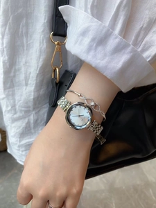 Detail of silver ladies quartz watch with rhinestone markers and matching bracelet set