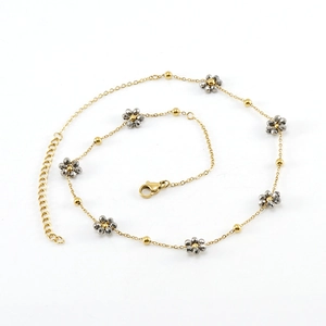 Minimalist gold chain necklace featuring crystal flower charms and faceted gray beads