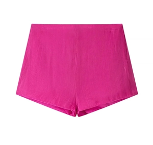 Detailed view of rose pink high-waisted shorts with vertical pleated chiffon texture