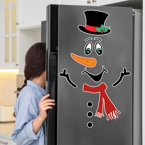 Magnetic snowman fridge decal set on dark grey refrigerator in a modern kitchen