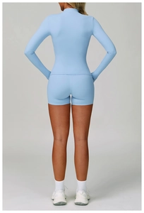 Close-up back view of light blue seamless yoga set showing high-waist shorts and stand collar