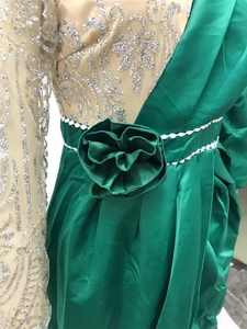 Detail of green satin gown with silver sequins and 3D floral waist decoration