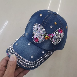 Denim baseball cap featuring silver rhinestones and a colorful bow design pattern