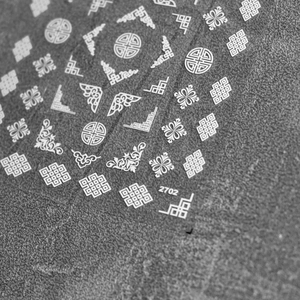Macro detail of white embossed 3D nail stickers with traditional Chinese knots and patterns