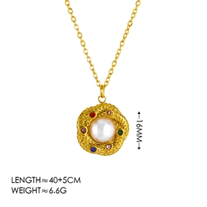 Vintage gold necklace with large white pearl pendant and colorful zircon accents on white base