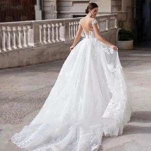 Elegant sleeveless backless lace wedding dress with a long train in ivory white
