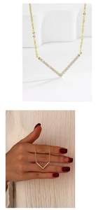 Macro shot of V-shaped gold pendant with cubic zirconia and hand display for size reference