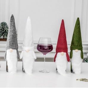 Detailed view of four gnome wine bottle covers in grey, white, red, and green felt