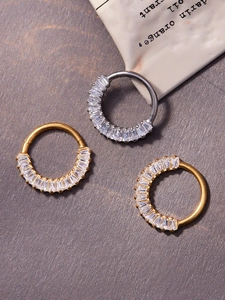 Detail of 18k gold and silver plated titanium nose rings with rectangular zircon stones