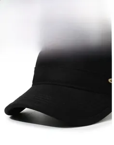 Detail of black cotton flat top hat featuring sturdy brim stitching and gold metal button