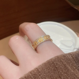 Detail of 24K gold plated flower ring with sparkling zircon inlays on model hand