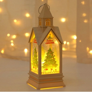 Detail of a beige Christmas castle lantern with LED warm light and festive engraving