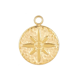 Detail of a golden round stainless steel pendant with starburst and hammered texture