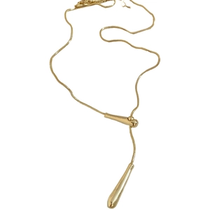 Minimalist golden Y-shaped snake chain necklace with sleek metallic teardrop pendant
