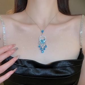 Silver butterfly necklace set with blue crystal tassels and shimmering star sparkles